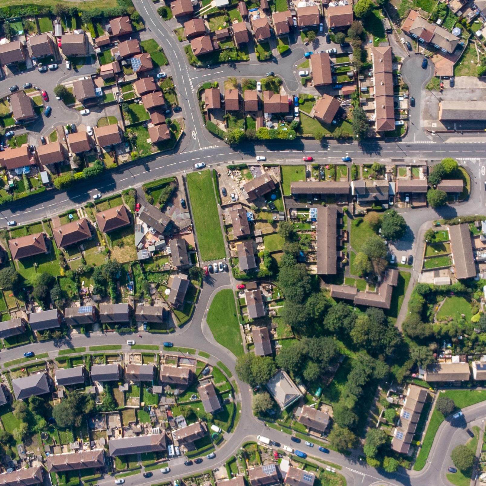 Aerial photo of the British town of Middleton in Leeds West Yorkshire showing typical suburban housing estates with rows of houses, taken on a bright sunny day using a drone.